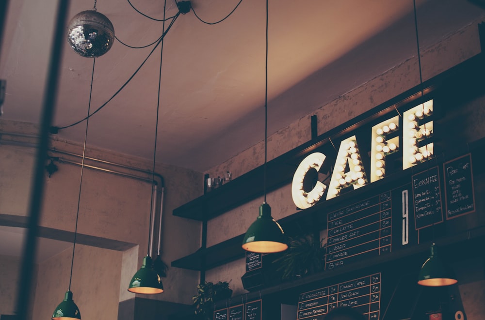 Freshly roasted coffee beans spread across a wooden surface with warm golden light